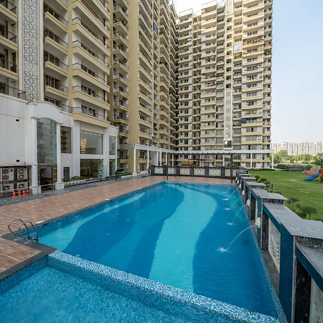 Resort-style swimming pool at AIGIN Royal surrounded by residential towers