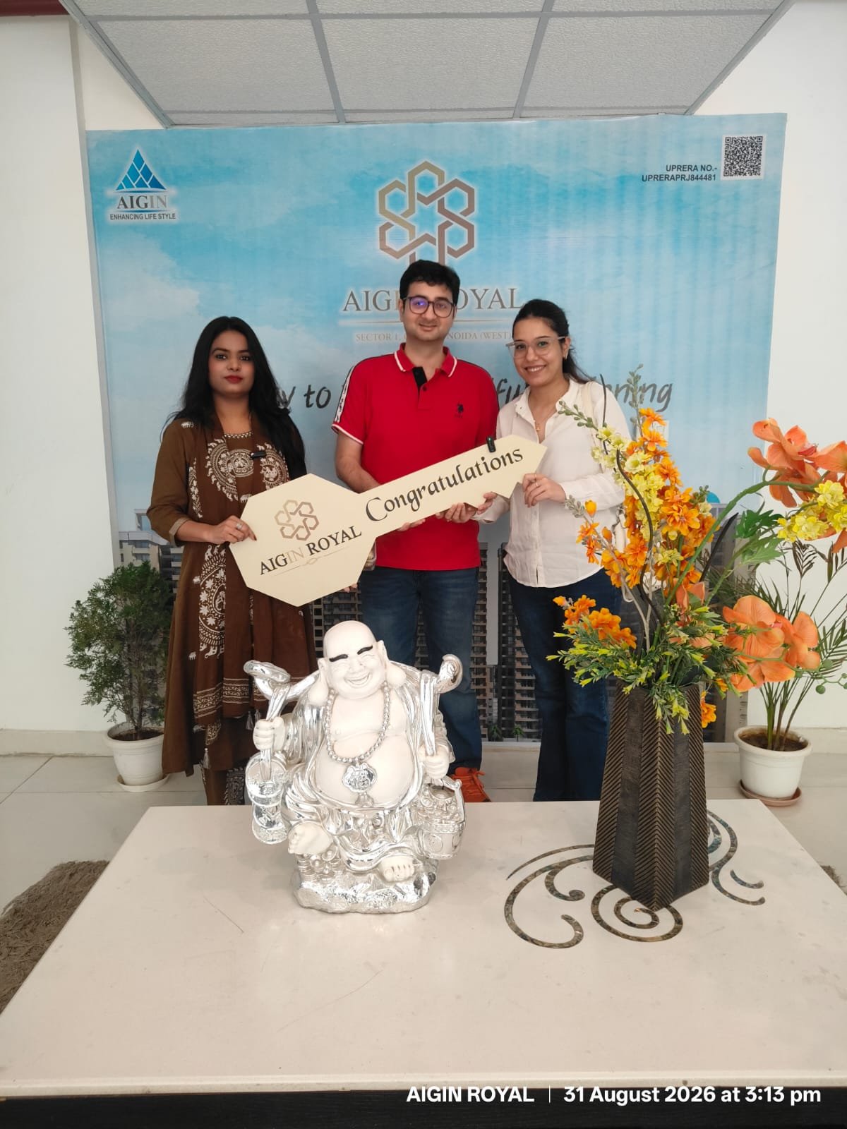 A couple celebrating the handover of their new AIGIN Royal flat